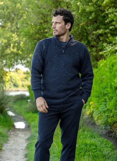 Man wearing navy Glenstone Contrast half zip sweater walking on nature path